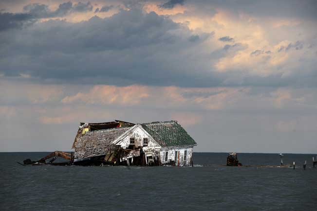 The last house on Holland Island in Chesapeake Bay, which once had a population of almost 400, finally toppled in October 2010. As the water rose and the island eroded, it had to be abandoned. Astrid Riecken for The Washington Post, via Getty Images